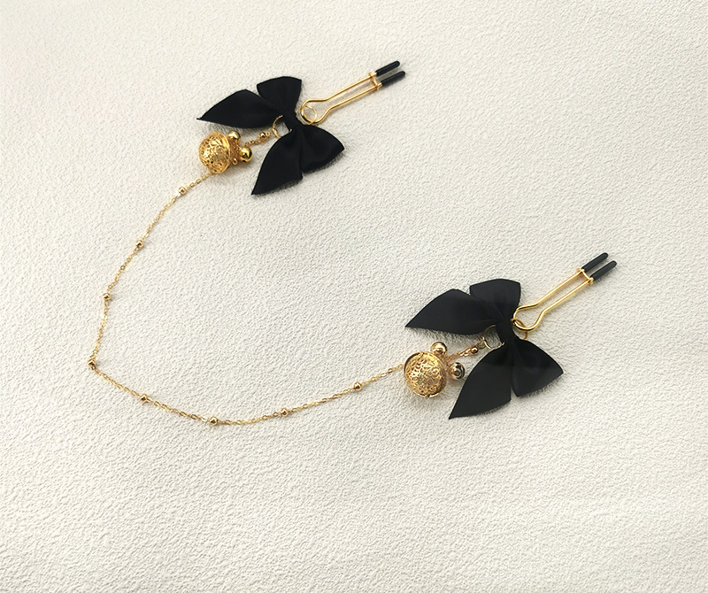 Black bow and gold-tone bell chain accessory