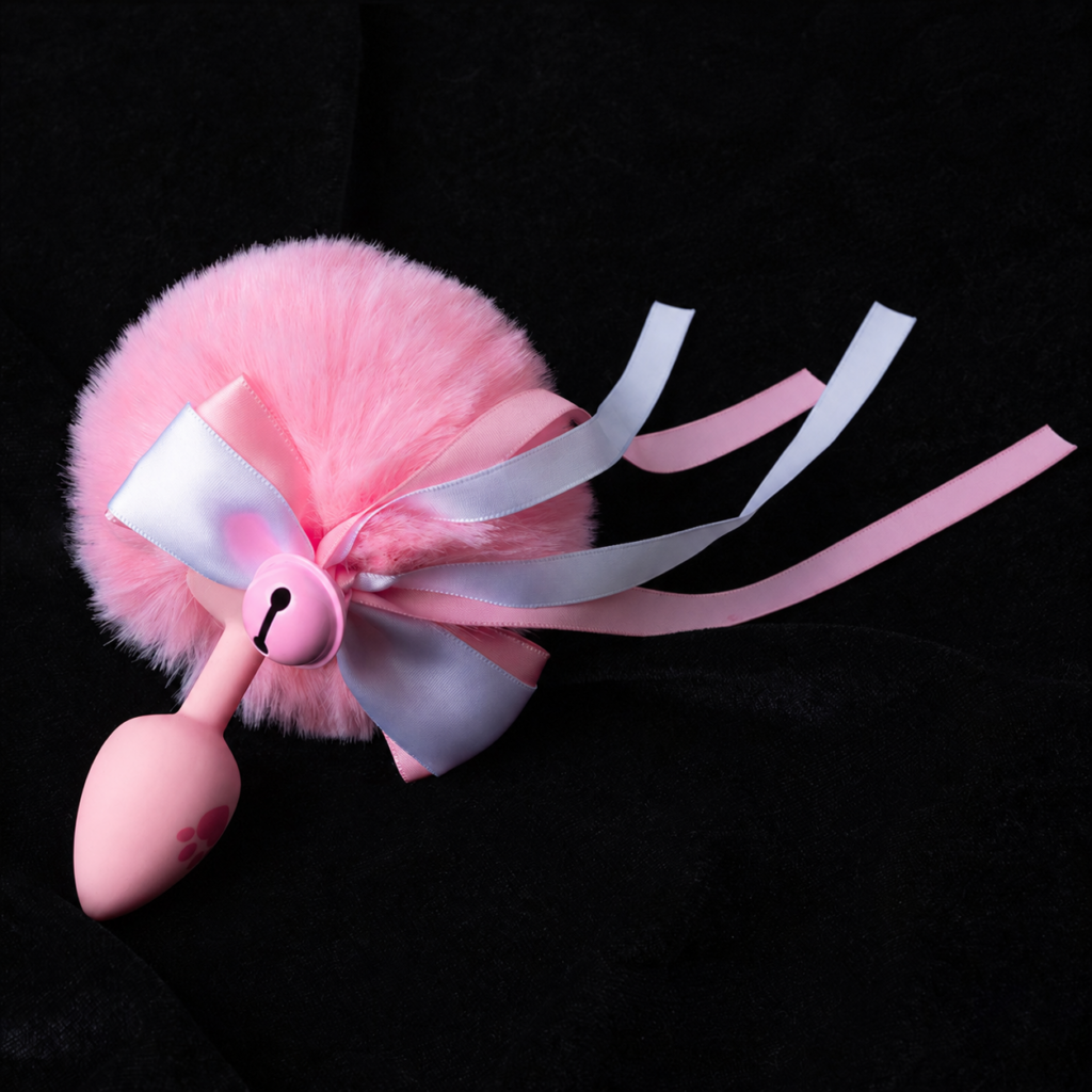 Pink bow-adorned pom-pom tail with a pink paw-print base